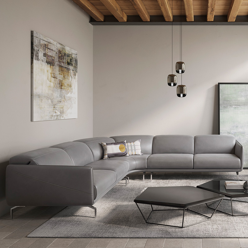 Corner sofa in gray leather with sleek metal legs, clean lines, and a spacious seat in a contemporary living room.