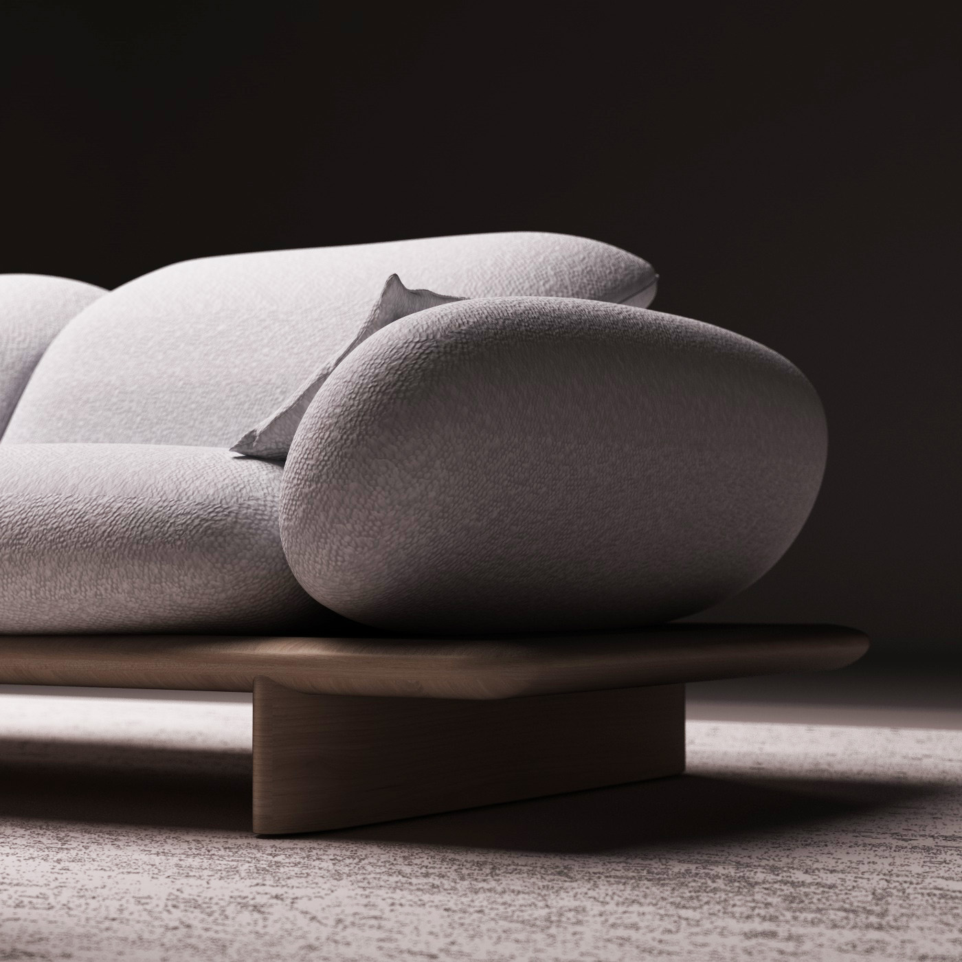 Canapé d’angle design gris clair aux formes organiques, accompagné de tables basses en bois sur une plateforme éclairée, dans une ambiance minimaliste et contemporaine.