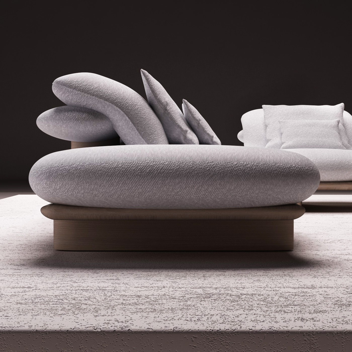 Light gray sectional sofa with organic shapes, paired with wooden coffee tables on an illuminated platform, in a minimalist and contemporary setting.