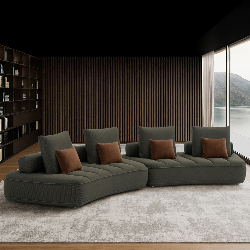 Canapé modulaire contemporain de couleur anthracite, composé de trois modules courbés avec assises matelassées et plusieurs coussins rectangulaires assortis.
