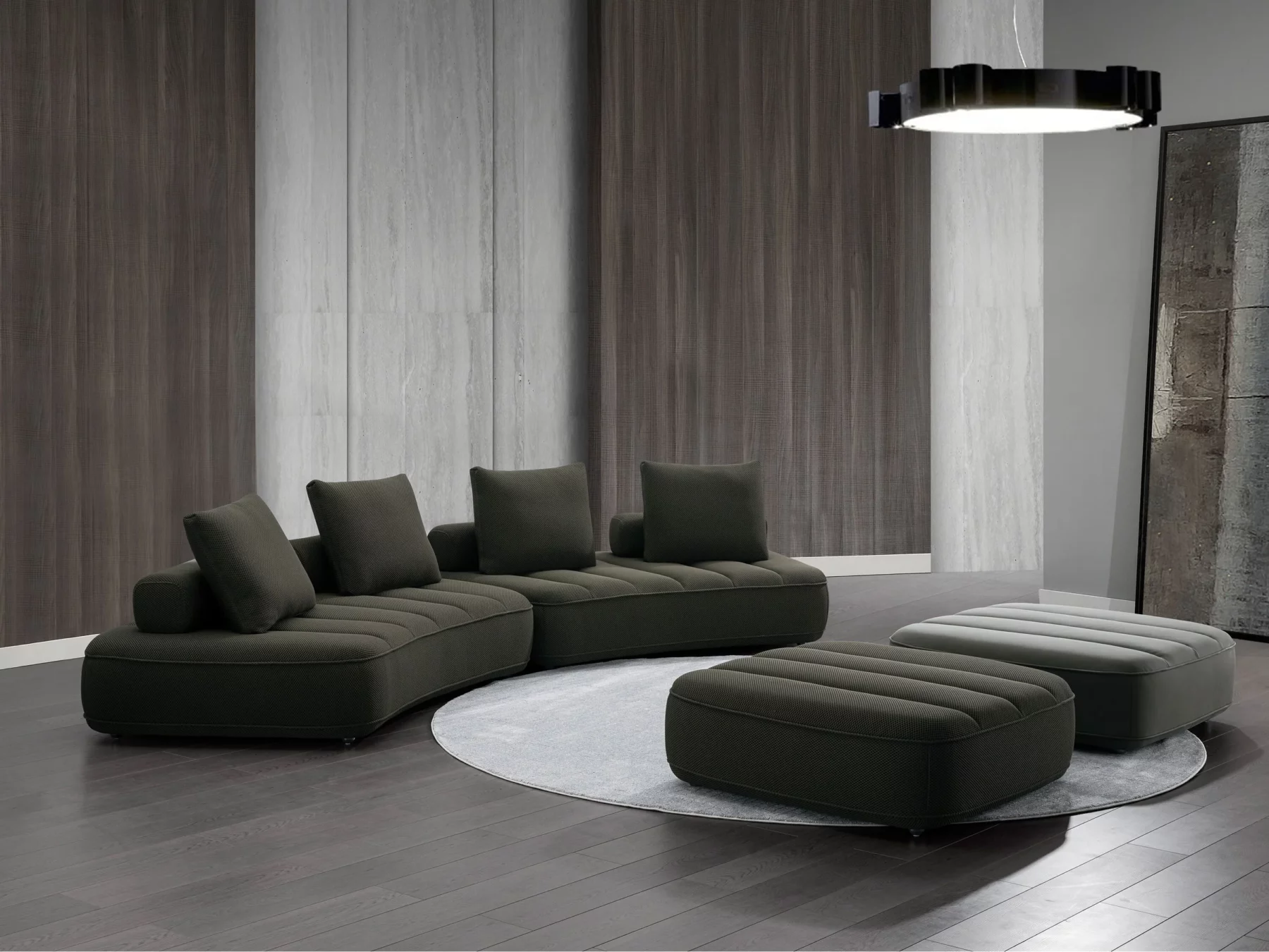 Canapé modulaire contemporain de couleur anthracite, composé de trois modules courbés avec assises matelassées et plusieurs coussins rectangulaires assortis.