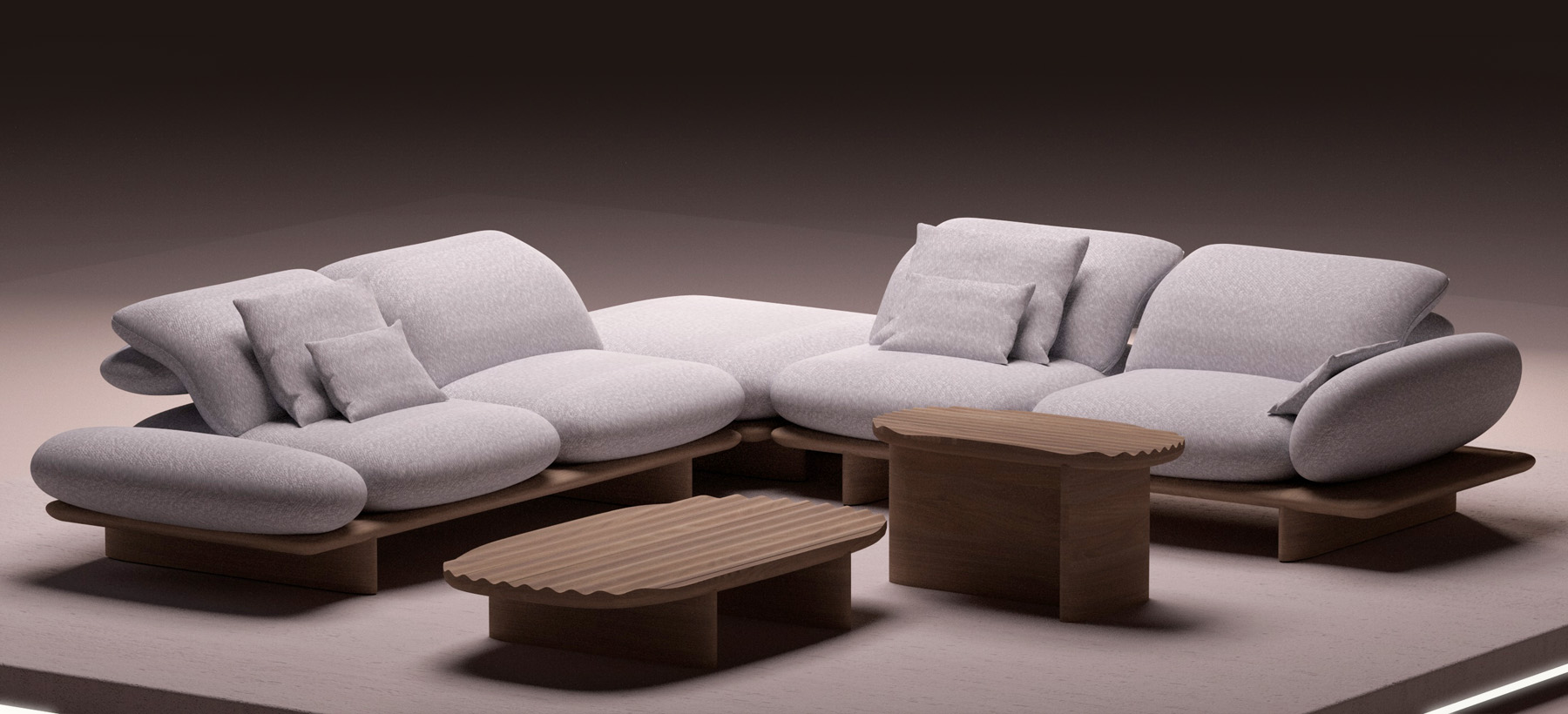 Light gray sectional sofa with organic shapes, paired with wooden coffee tables on an illuminated platform, in a minimalist and contemporary setting.