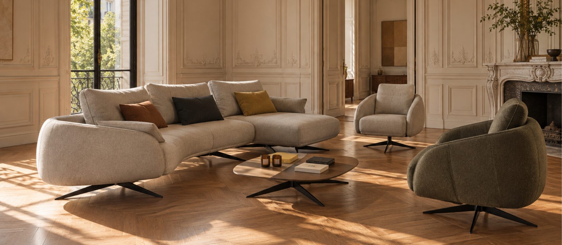 Generously proportioned sofa with organic lines, paired with sculptural armchairs in a light-filled classic Parisian interior.